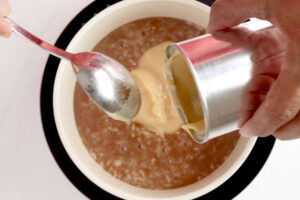 Adding milk.
