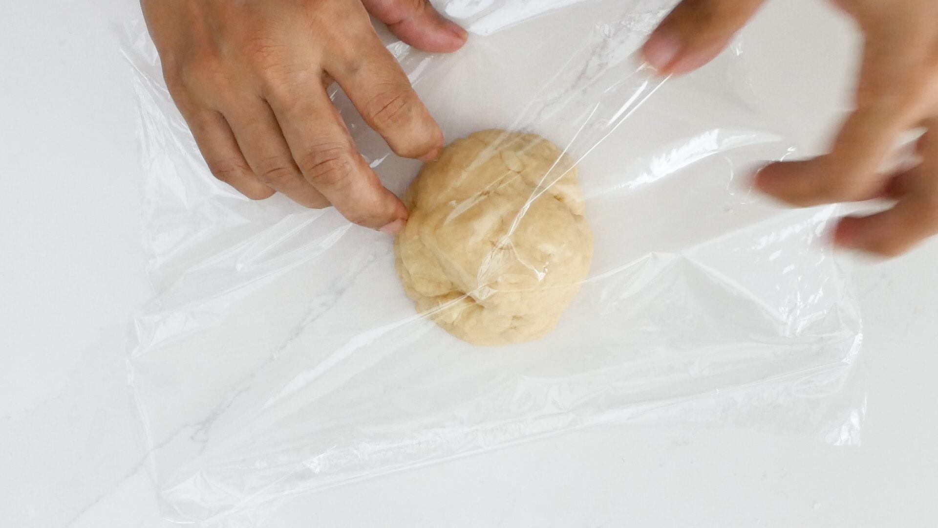Wrapping dough in plastic film