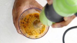 Blending chinola pulp.