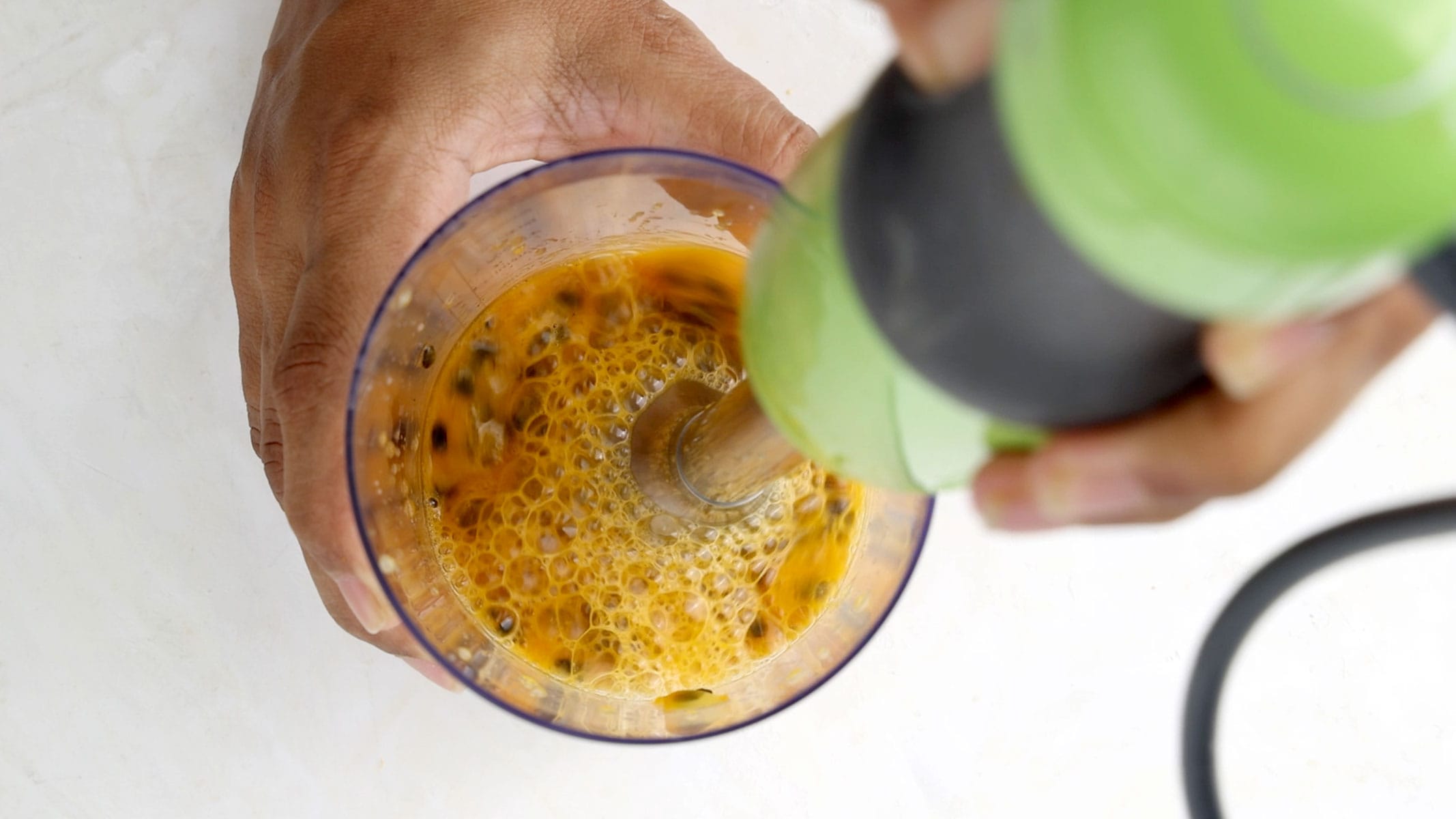 Blending chinola pulp.