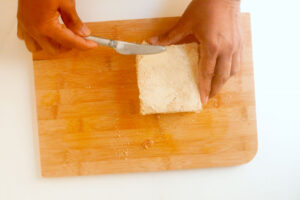 Buttering bread.