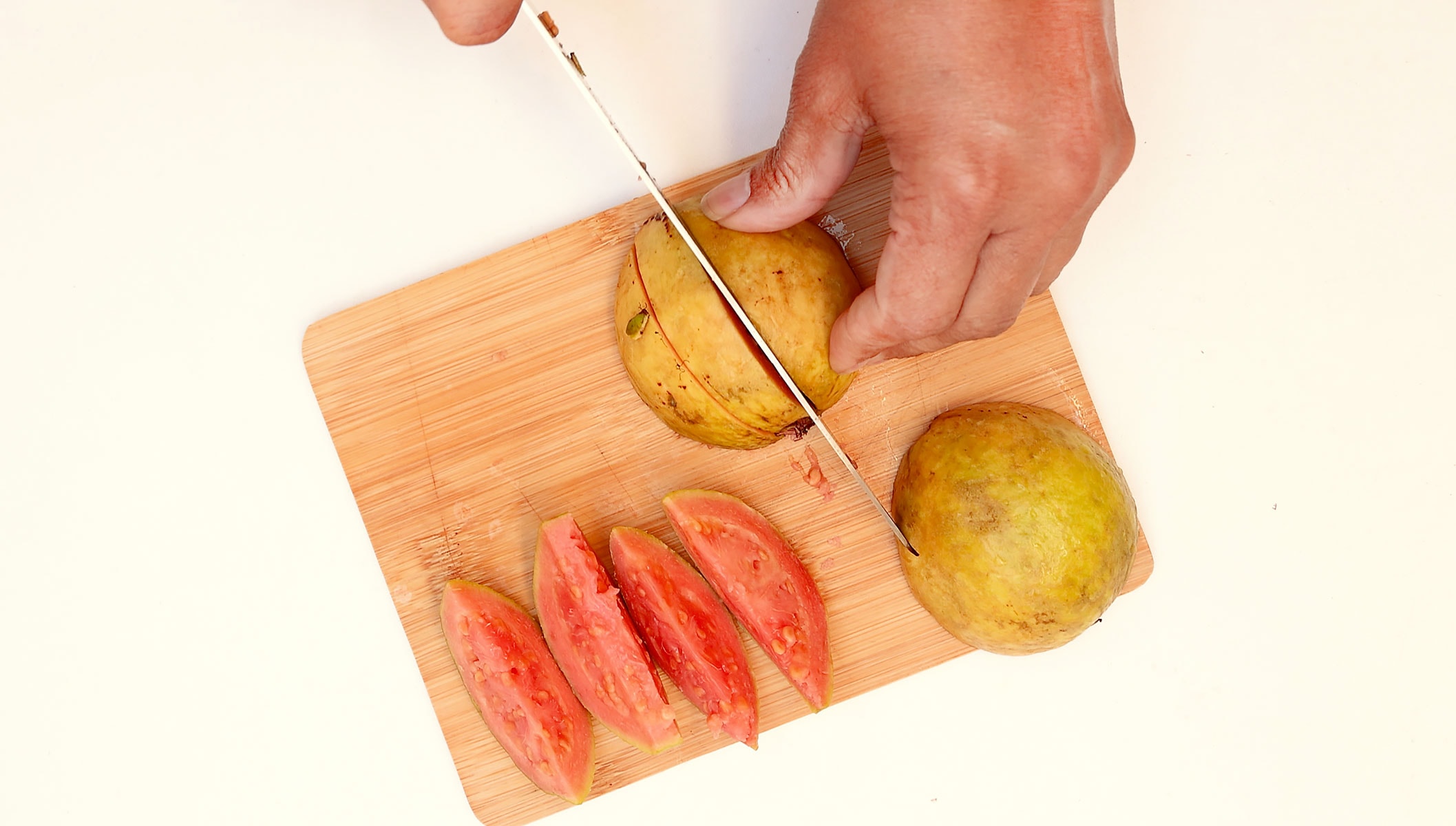 Chopping guava.