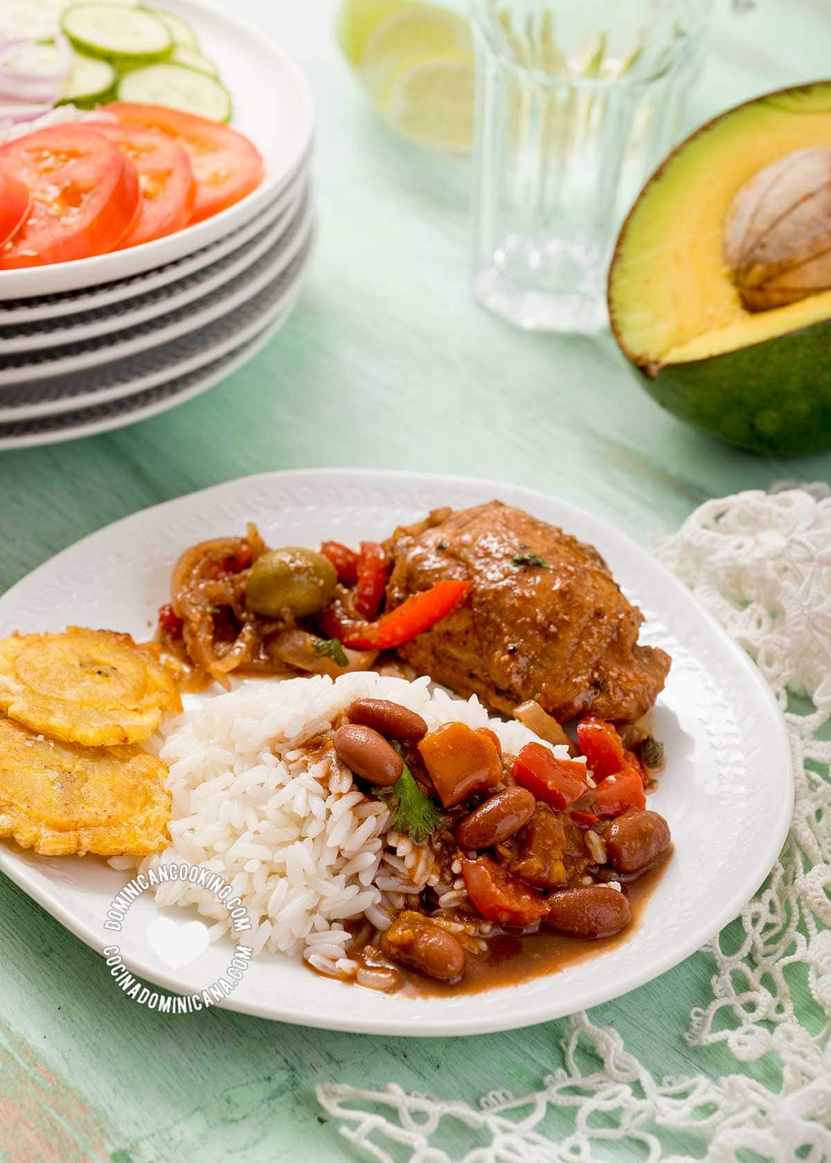 Dominican dish of rice, beans and chicken served with salad and avocado