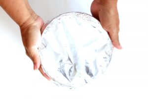 Wrapping ice cream cake for freezing.