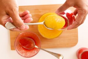Pouring fruits into jars.