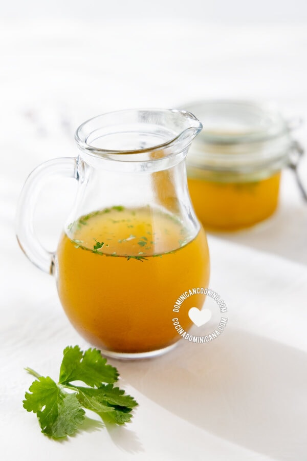 Homemade vegetable broth in pitcher and jar
