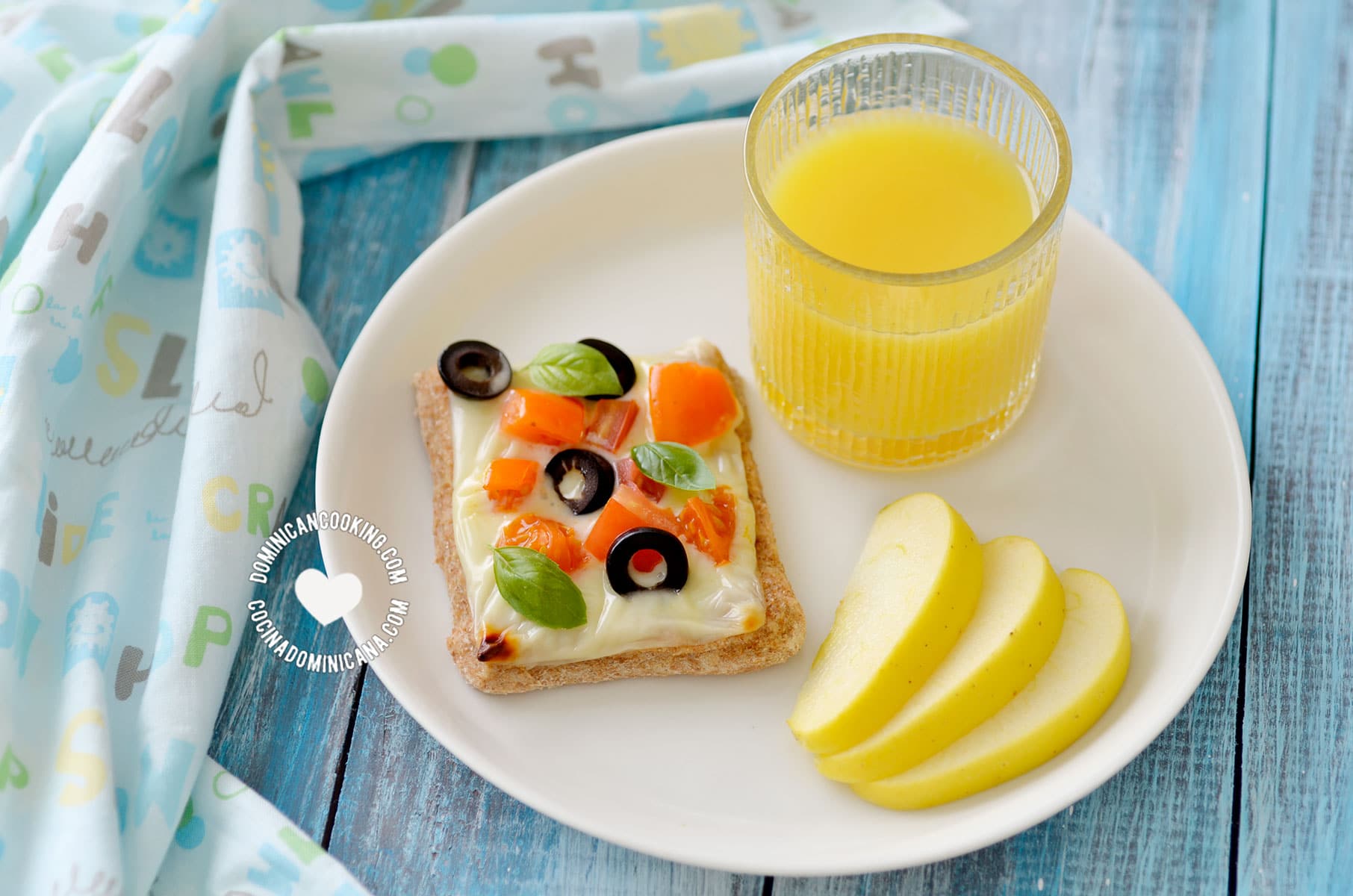 Whole Wheat Cheese and Veggies Tartlet Served with juice and an apple slices