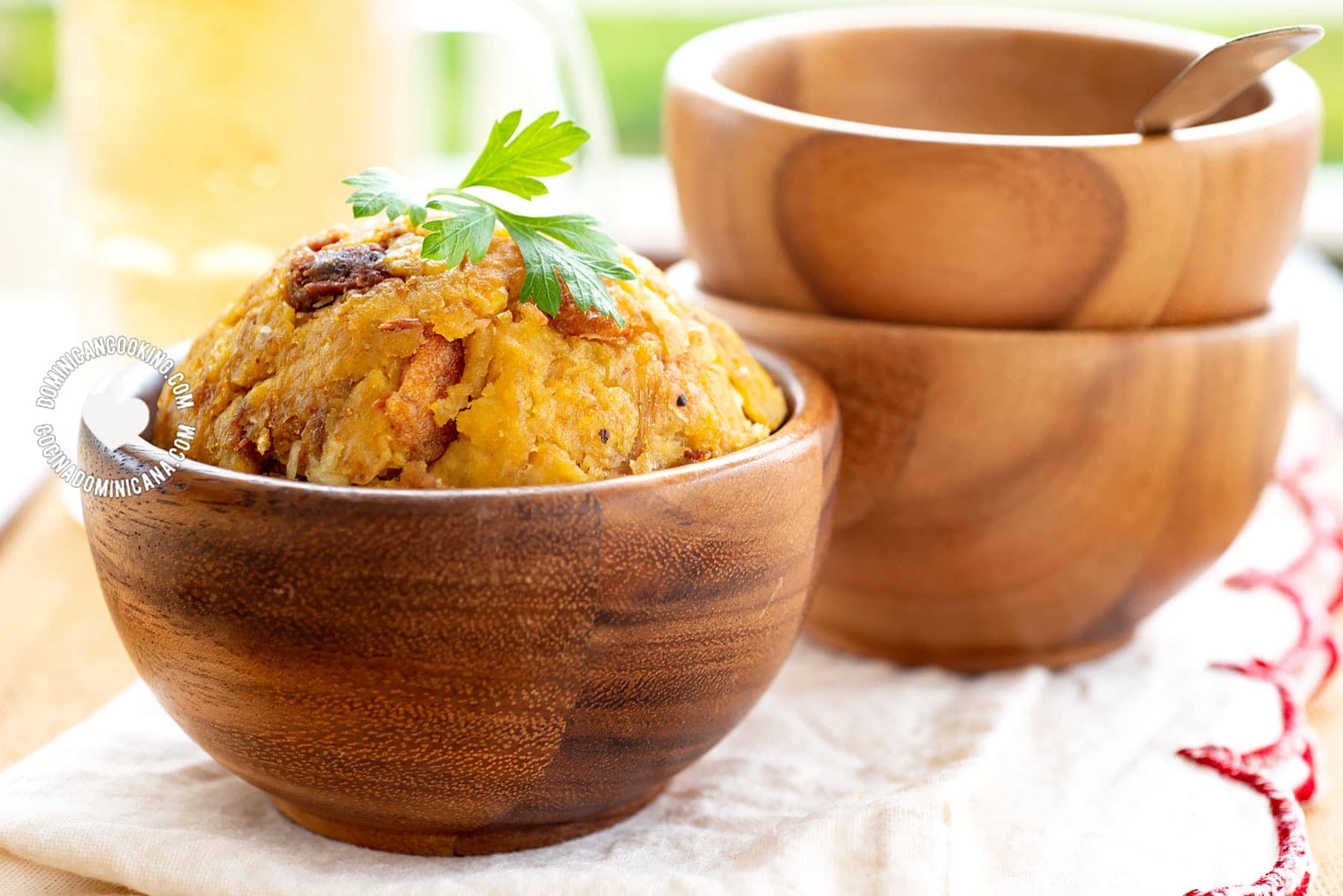 Bowl of fried mofongo with a bowl of broth.