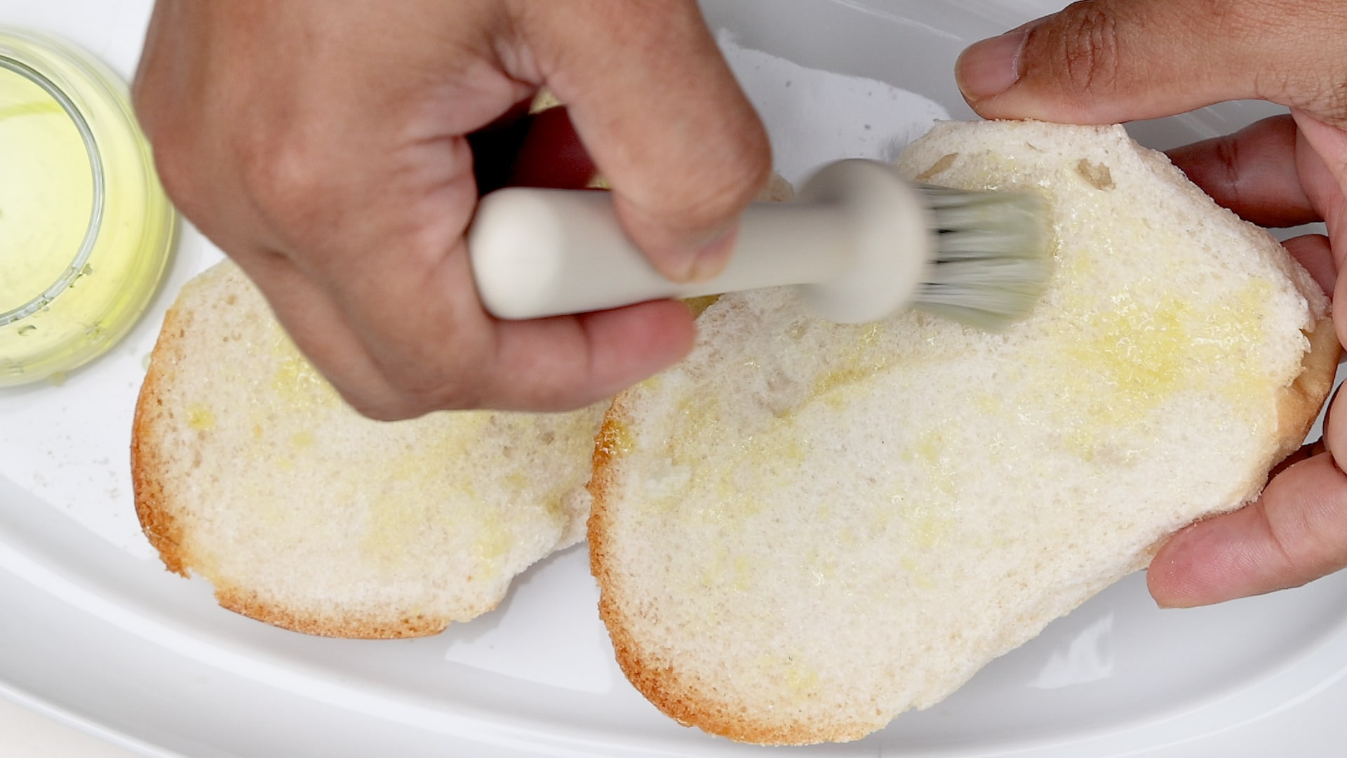 Brushing bread with oil.