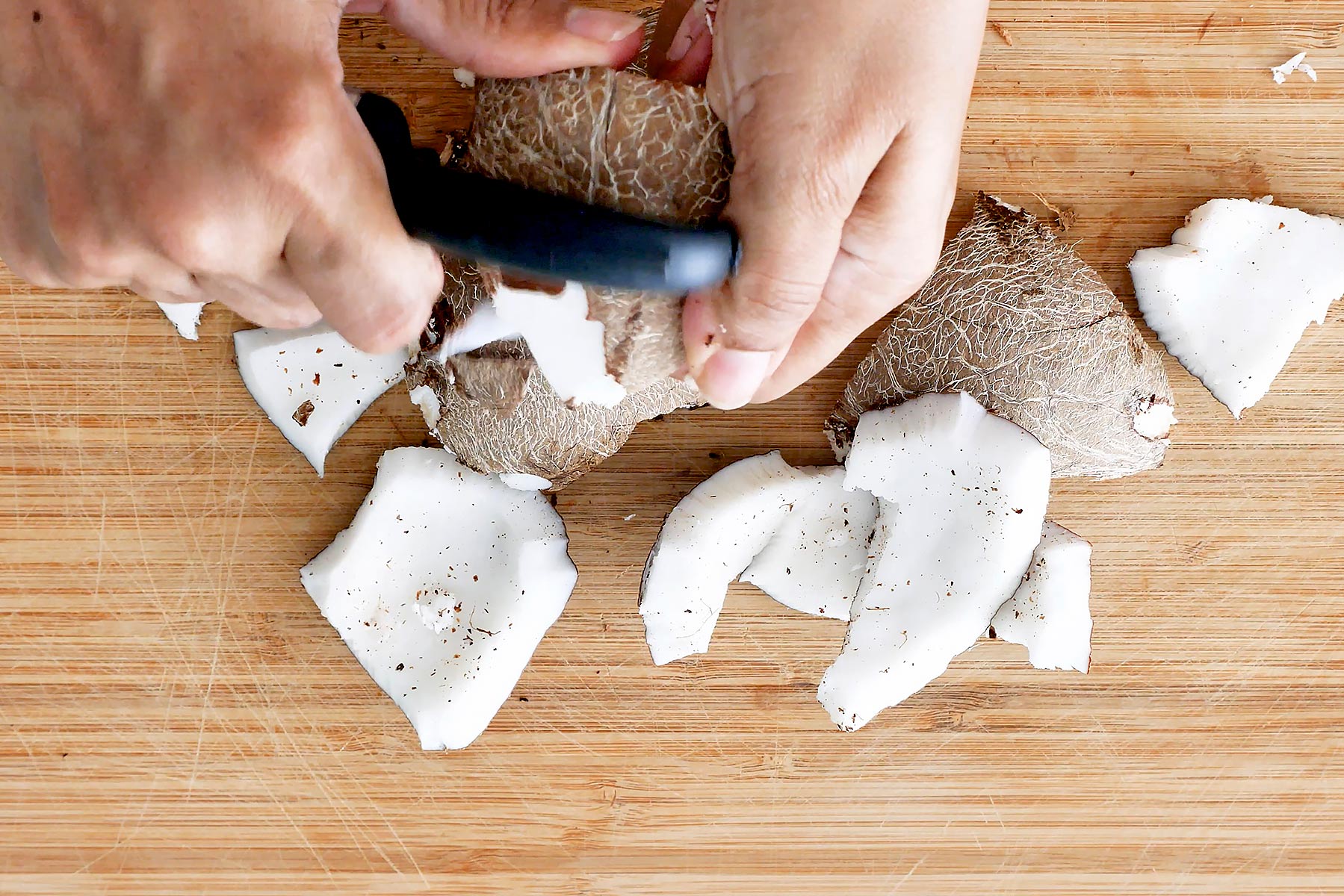 Peeling coconut meat.