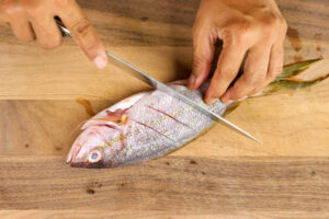 Making diagonal cuts into the fish