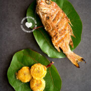 Fried fish (pescado frito) on leaves with fried plantains