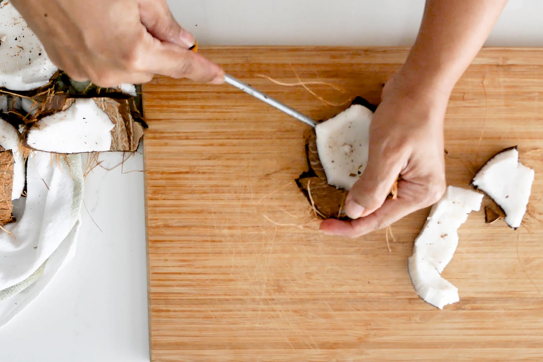 Separating coconut meat.