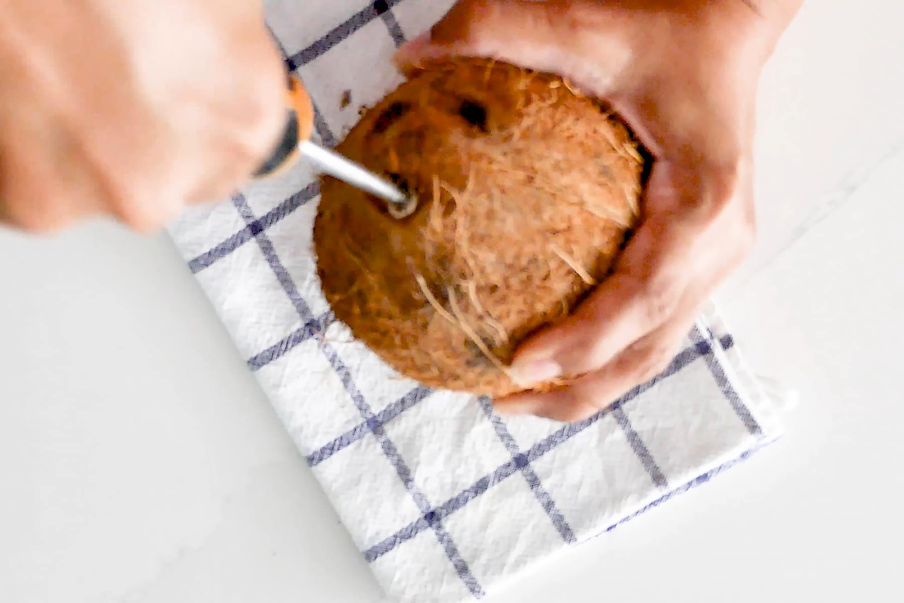 Poking coconut eyes.