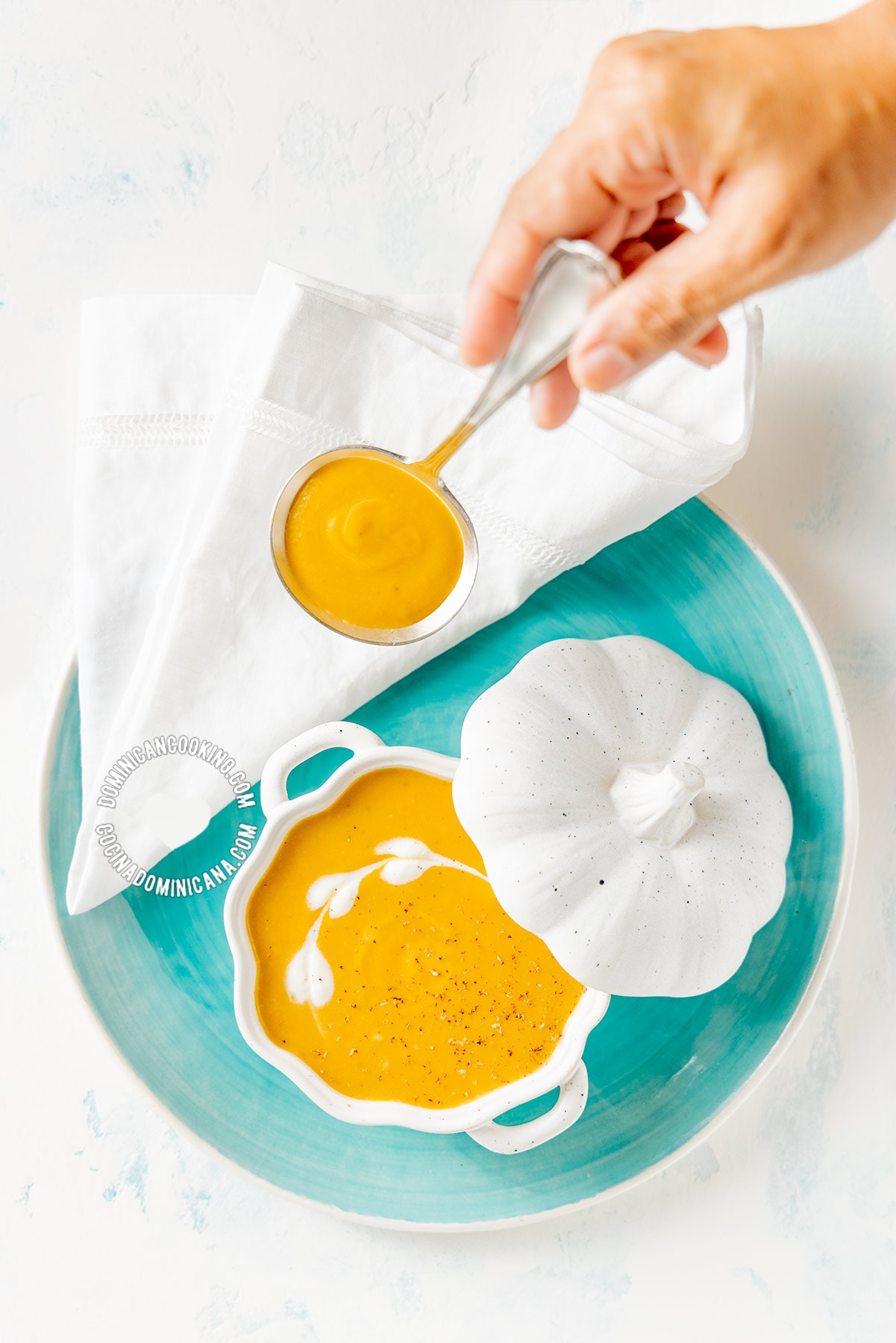 Crema de Auyama (Cream of Pumpkin Soup) and Hand Holding Spoon.