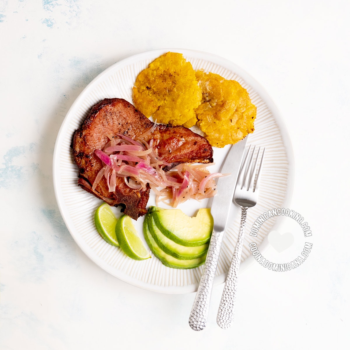 Chuletas fritas (Dominican Fried smoked oork chops) with tostones and avocado.