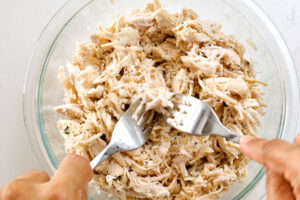 Shredding chicken with two forks