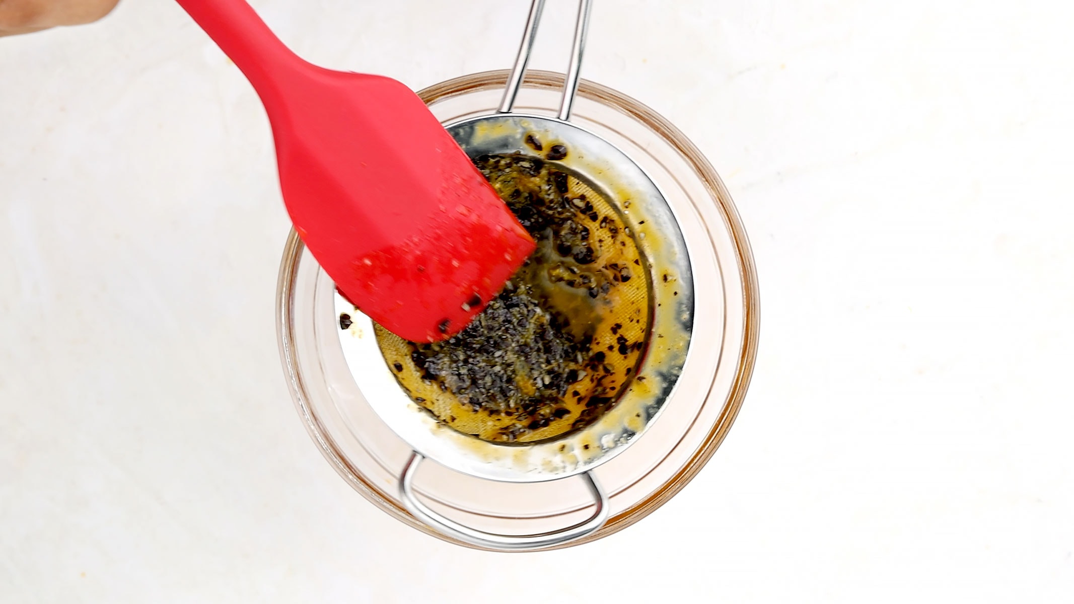Sieving passionfruit.